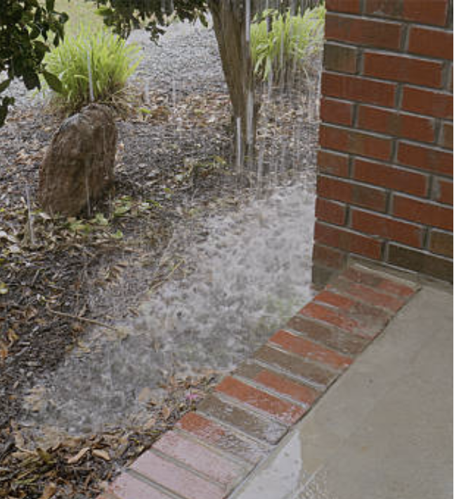 Water pooling around the house by blocked gutters