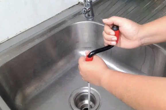 drain snake to clean kitchen sink drain